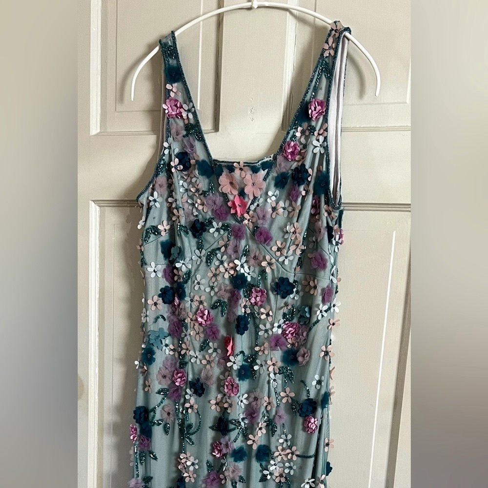 Beautiful below knee dress with lots of hand sewn stones and flowers. Never worn